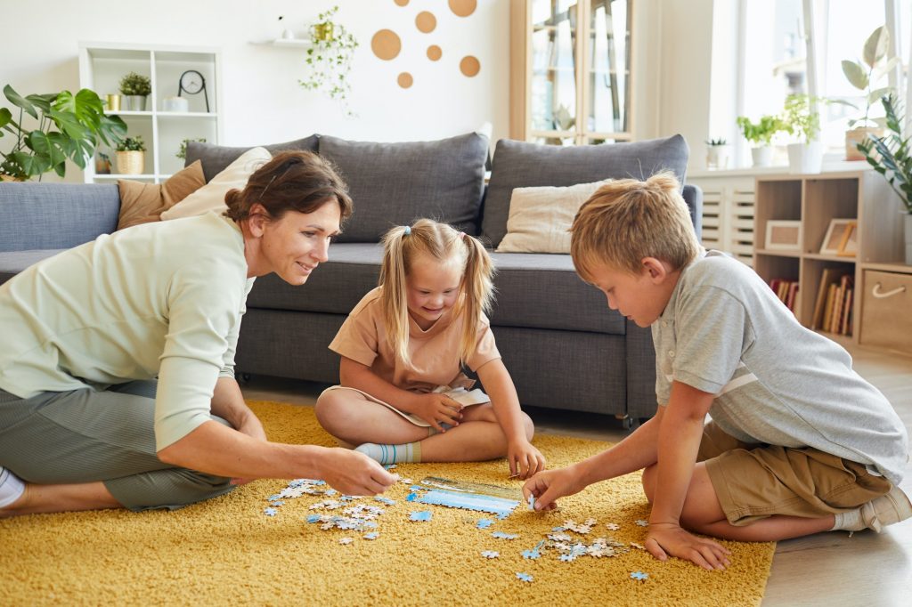 Family Playing Puzzle Game with Special Needs Girl